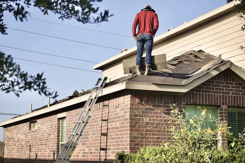 Professional roofer working on a residential roof in Fresno